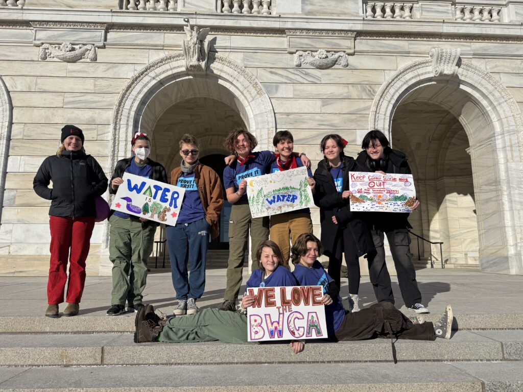 Students with handmade signs on the steps of the MN capital.