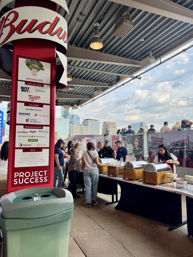 Photo from the sponsor area with the food out and the sponsor logos displayed.