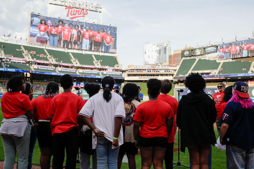 Photo from behind as students look out into Target Field.
