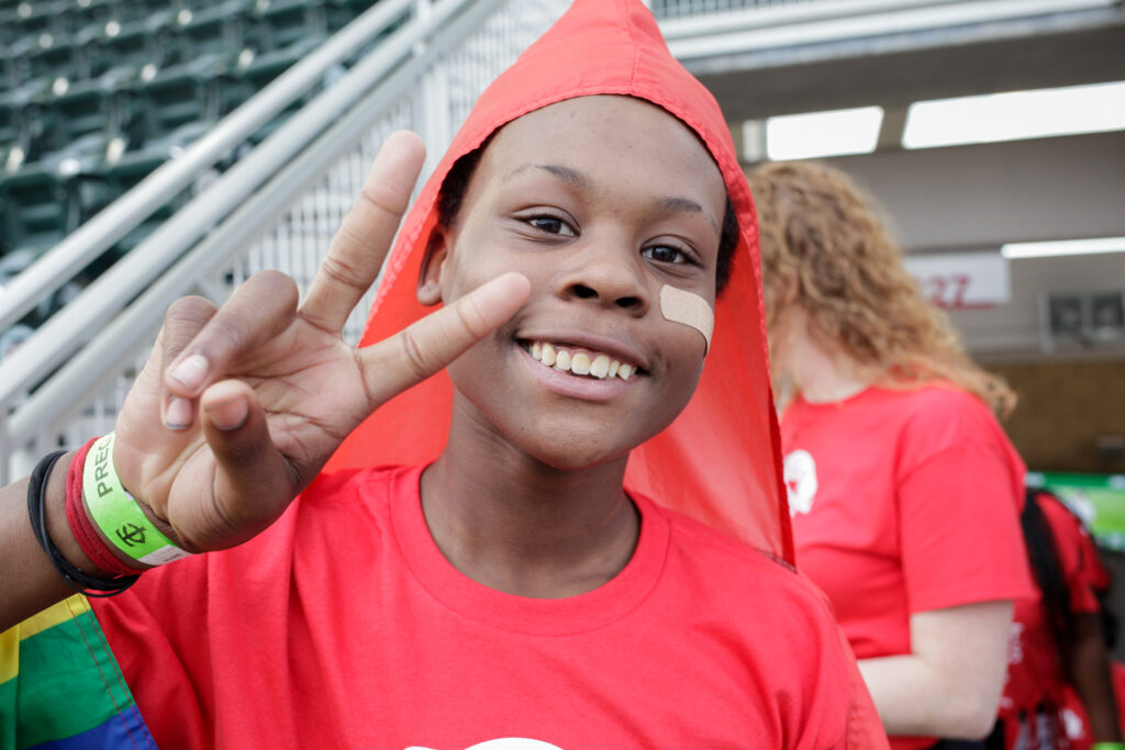 Student smiling and making a peace sign.