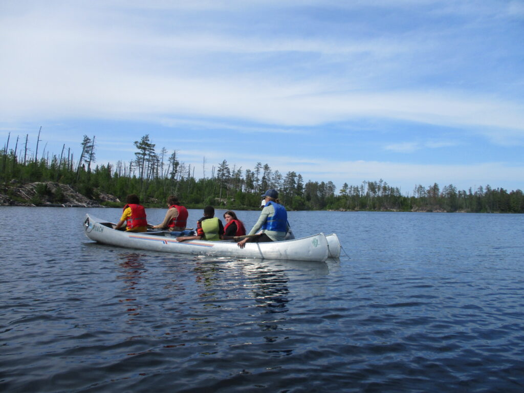 Group of students in a canoe.