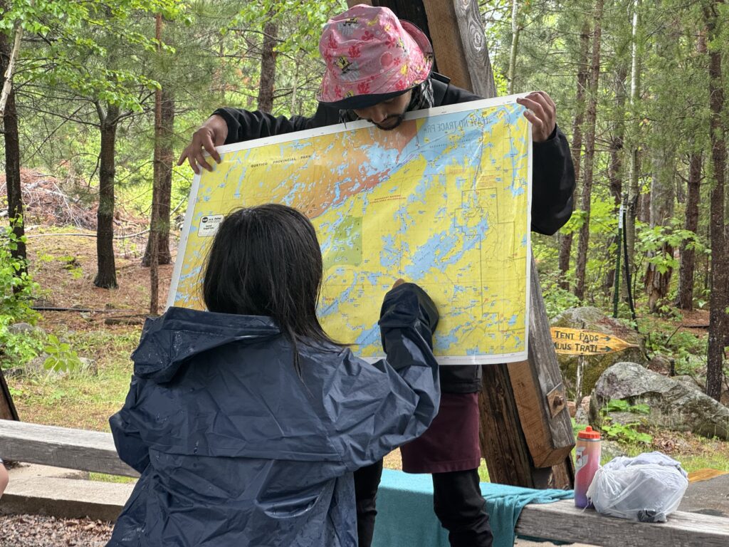 PS leader holding a map while student plots a course.