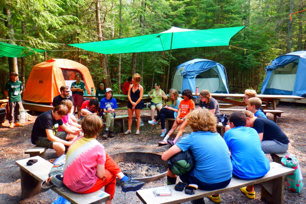 Apostle Islands group around a campfire.