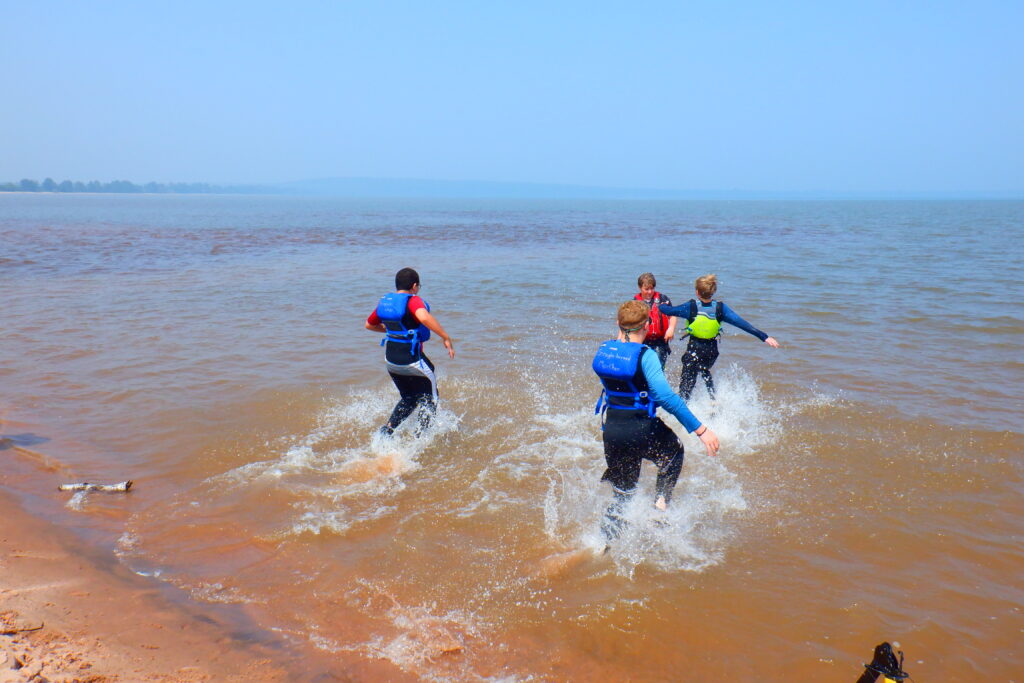 Students running into the water.
