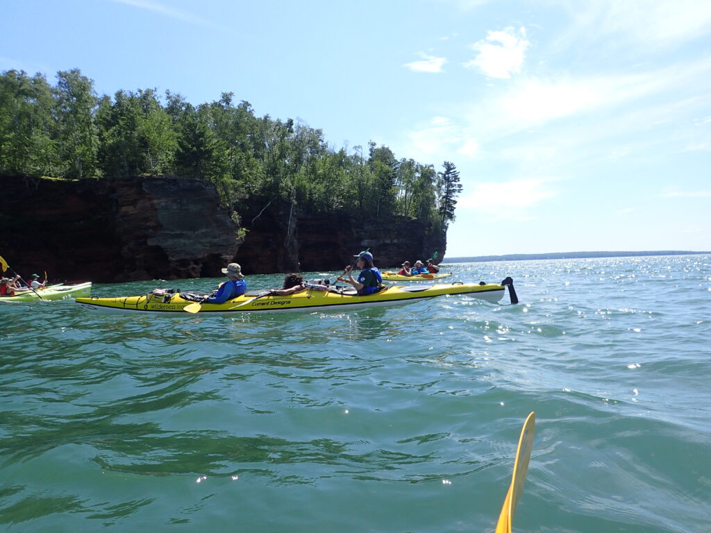 Students in their kayaks in lake superior.