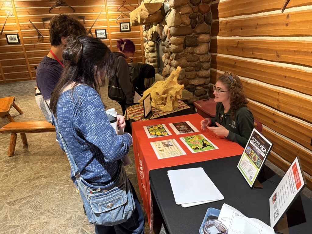 Students interacting with an instructor at the zoo.