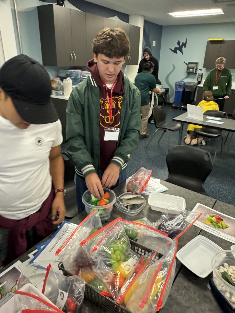 Students preparing meals for the animals at the zoo.