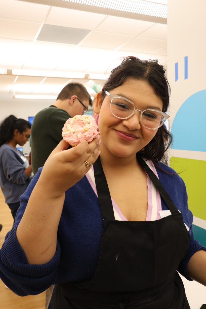Student showing off her decorated cupcake.