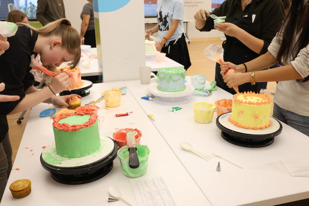 Students decorating cakes.