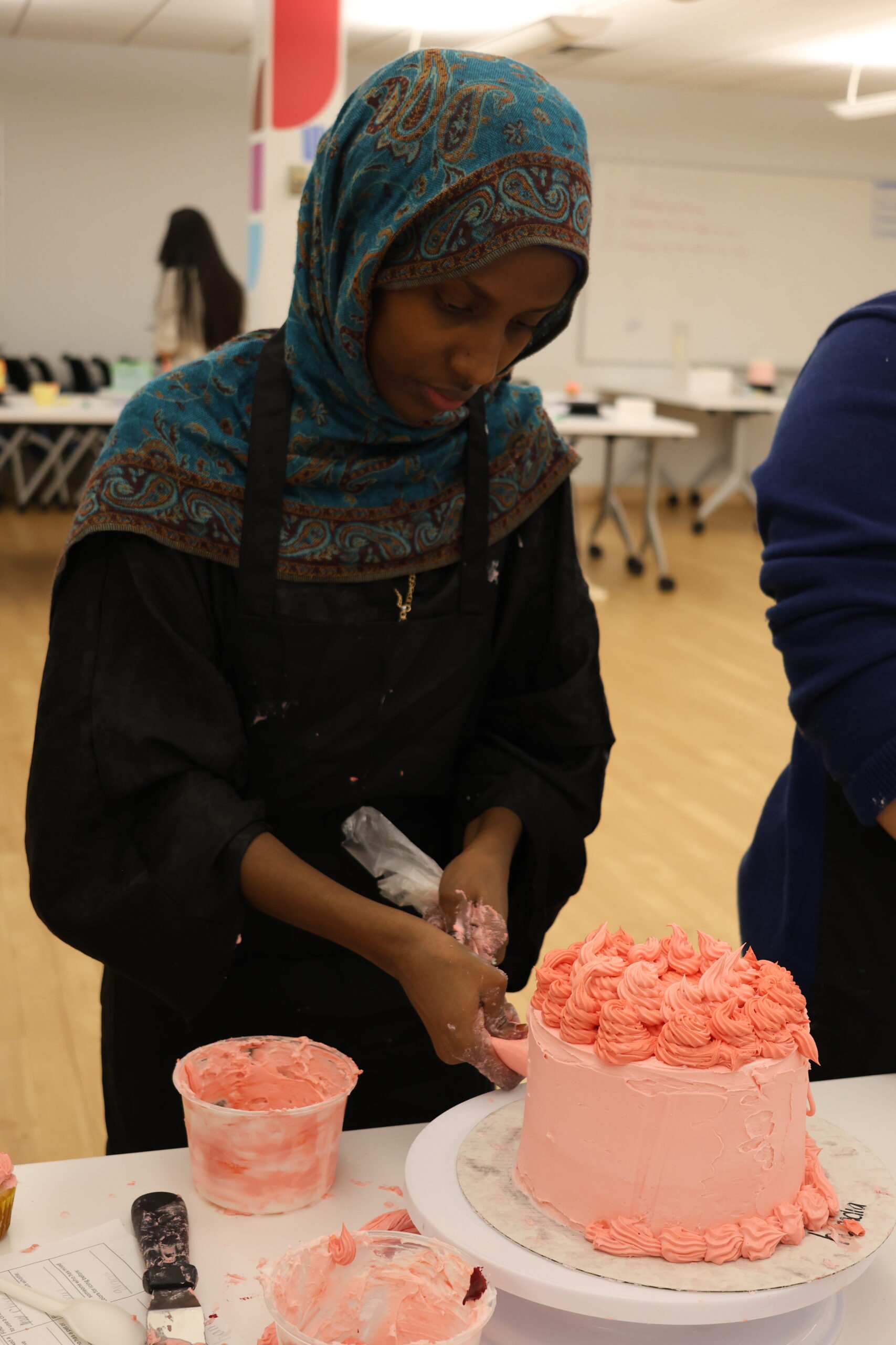 Student decorating cake.