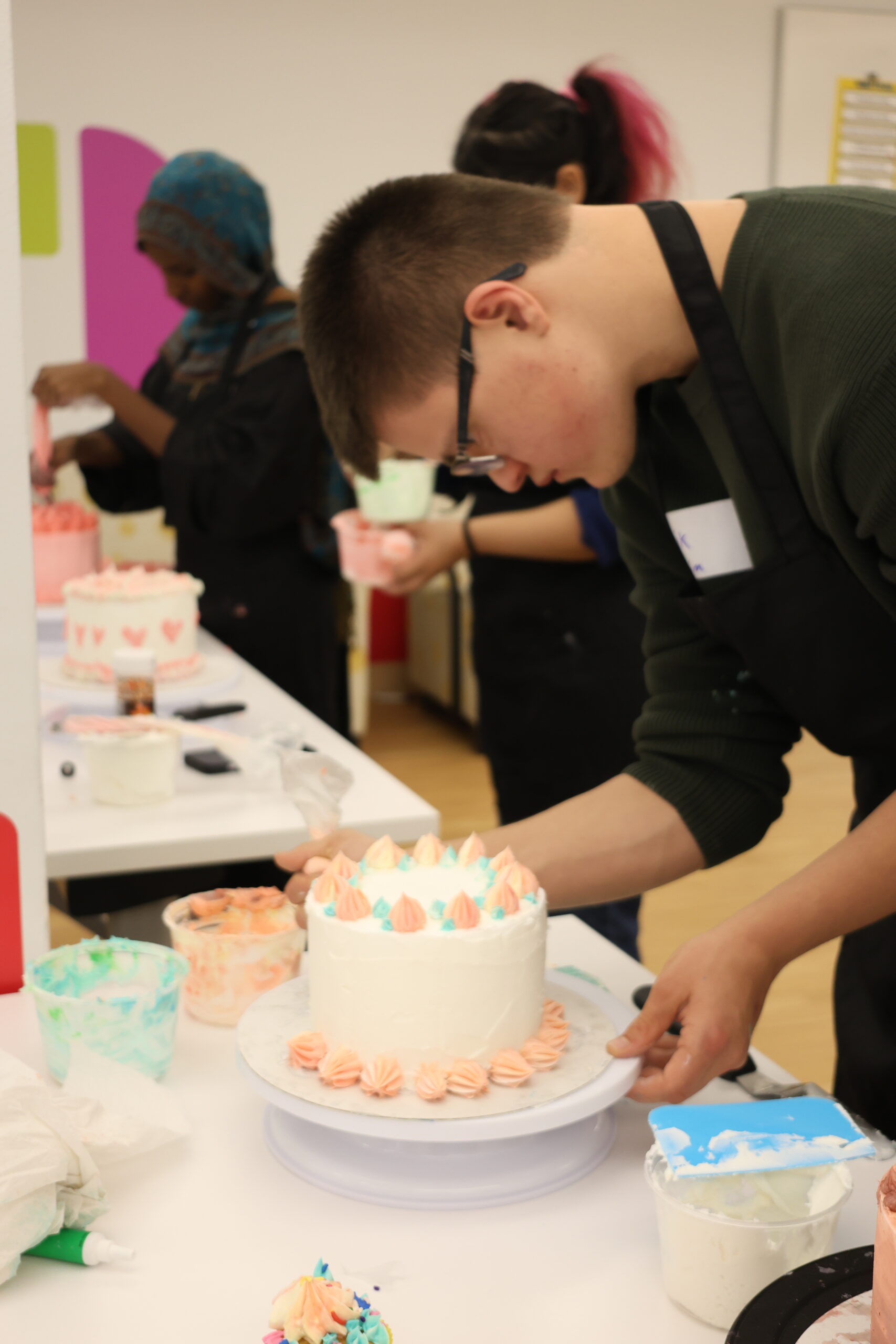 Student decorating cake.
