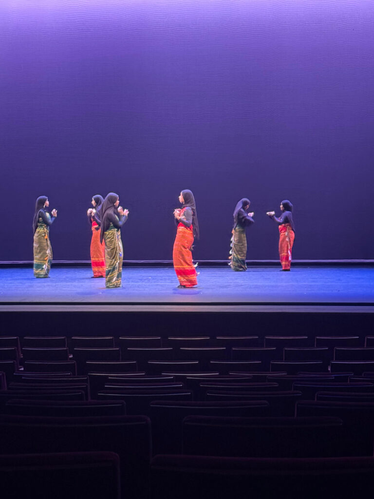 Six performers on stage.