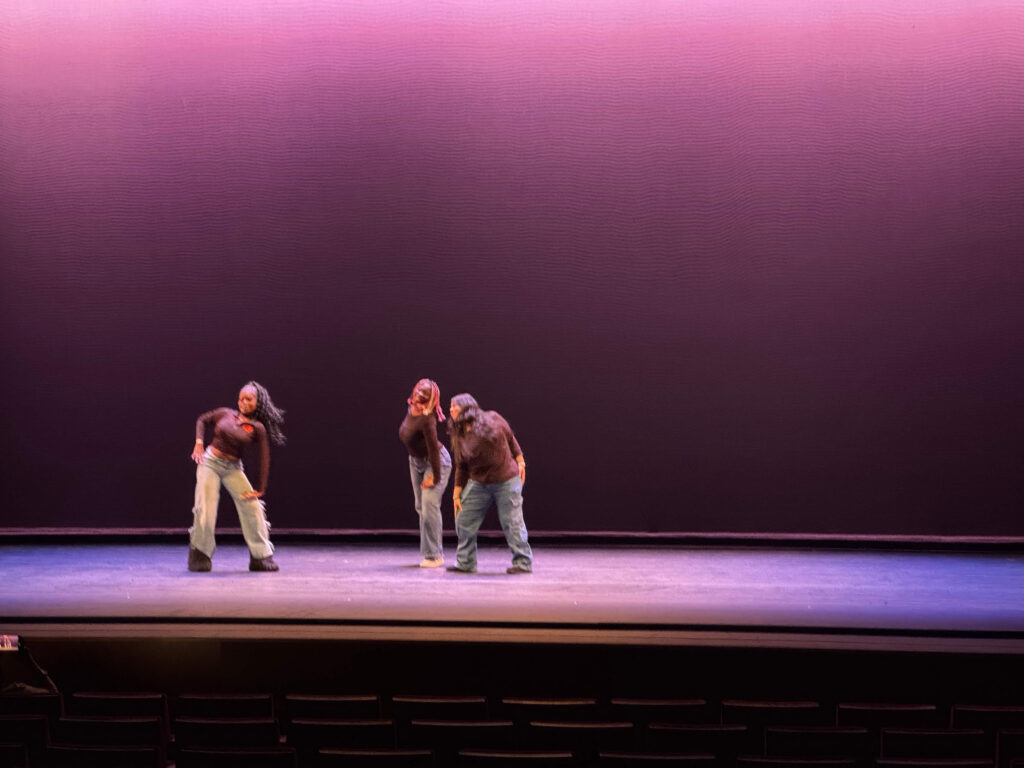 Three performers posing.