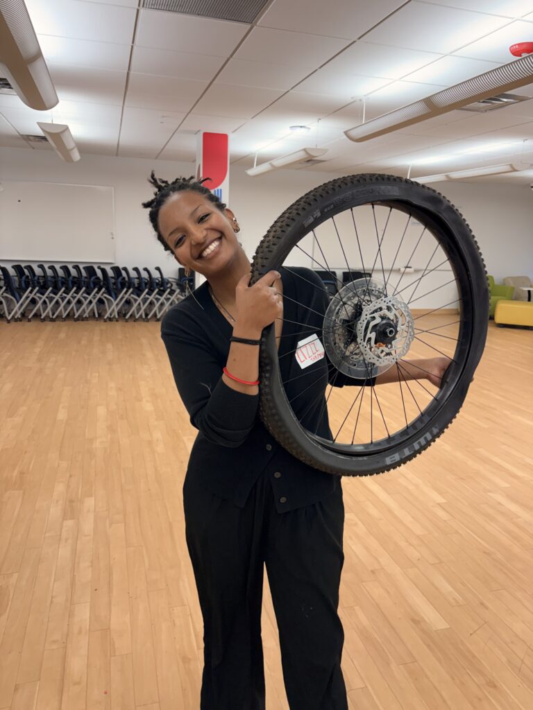 Picture of Liz with a bike wheel.