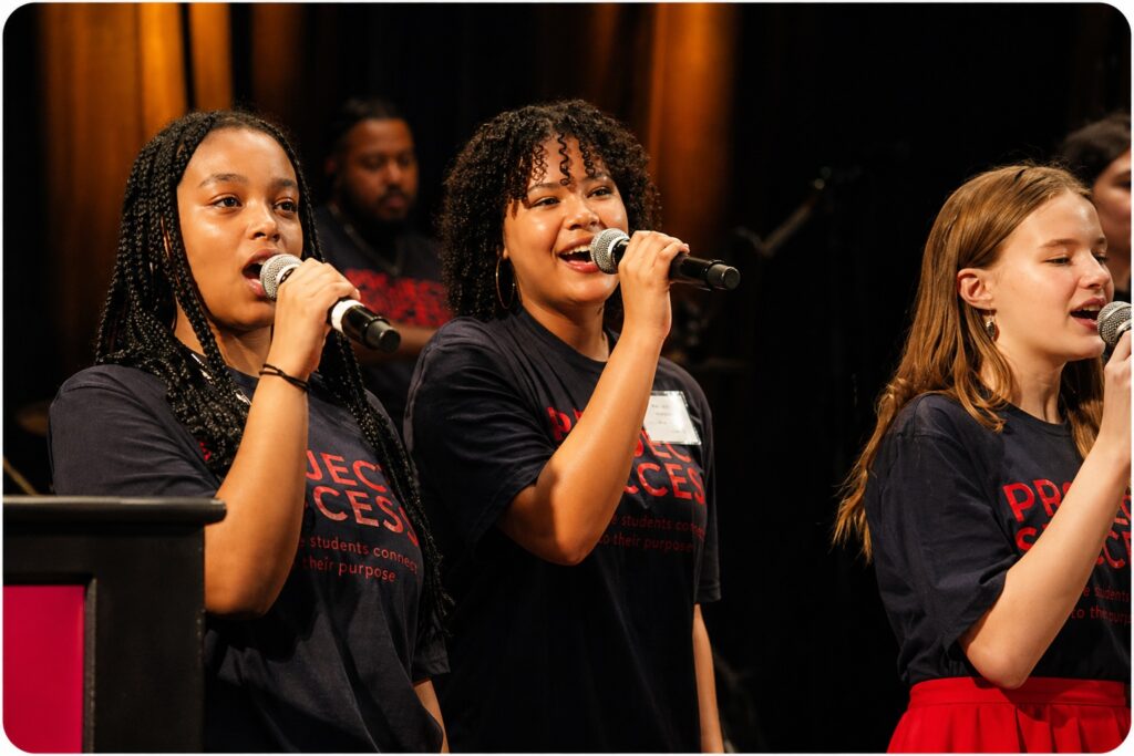 Students smiling and singing.