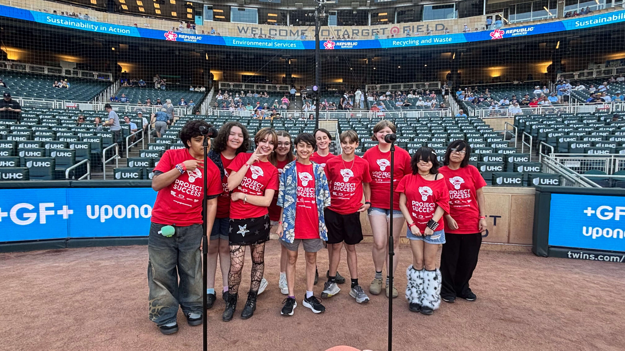Students singing on the field.