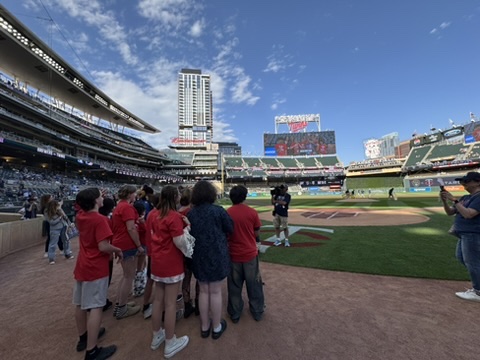 Students singing on the field.