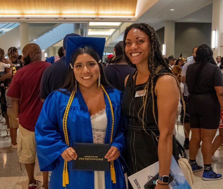 Alana and student at high school graduation.