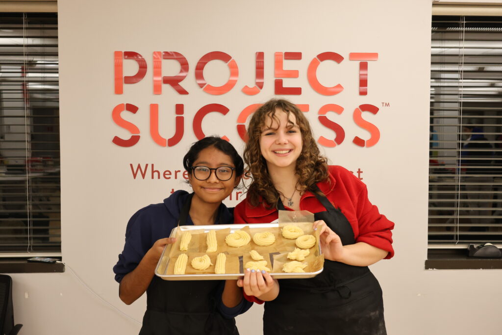 Students posing with churros they made in class