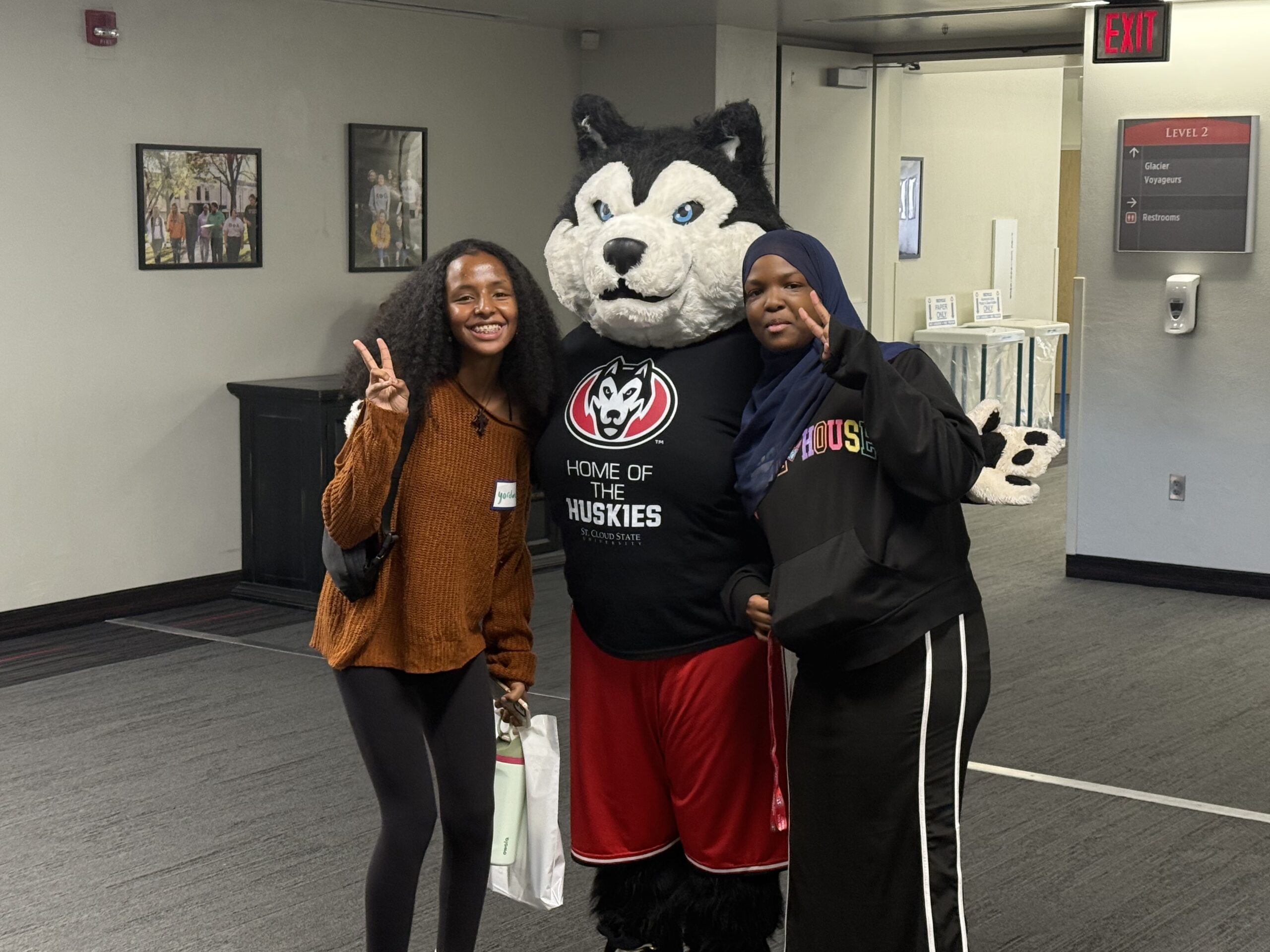 Students posing with St. Cloud State husky mascot