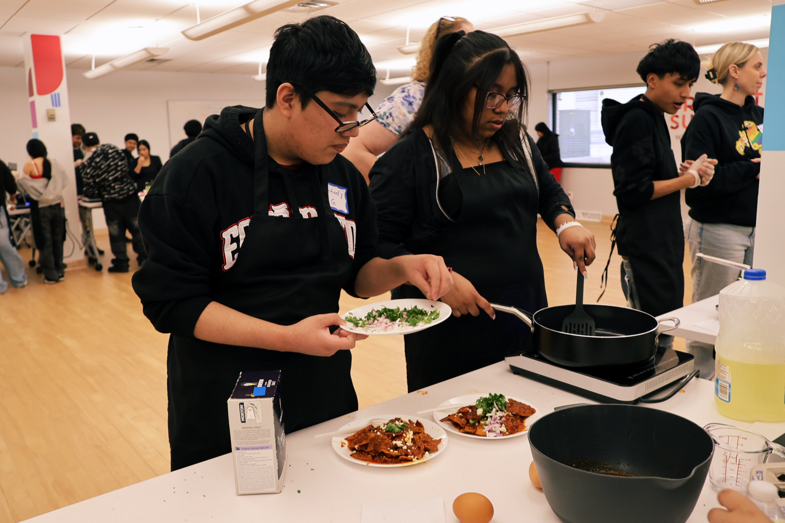 Two students cooking in the Institute Lab