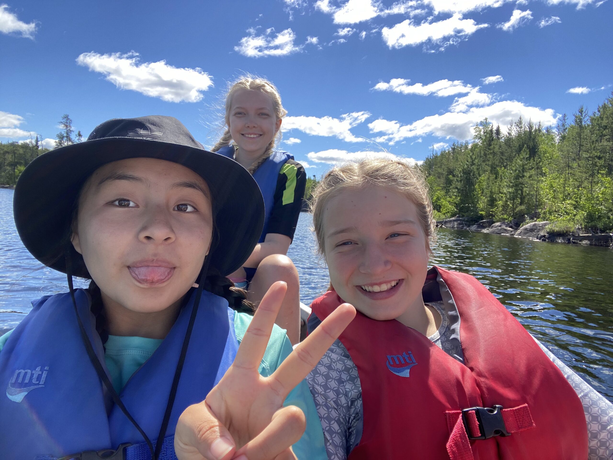three girls in a canoe in the BWCA